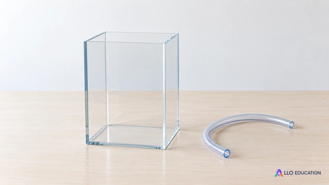 Un récipient transparent en forme de pavé et un court tuyau souple uni évoquent volume et remplissage, sans texte ni graduation.